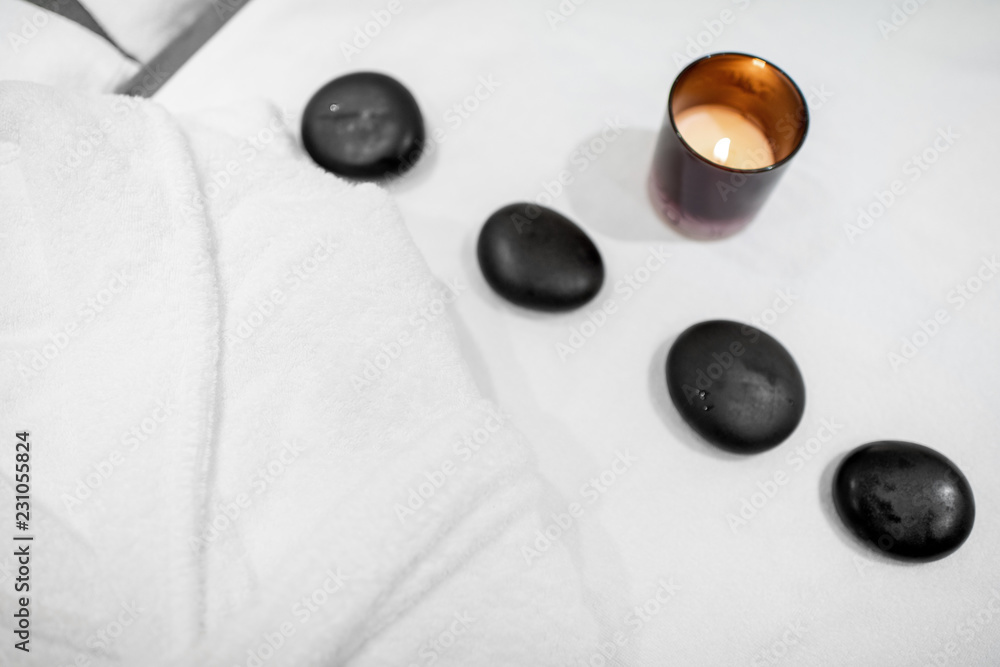Close-up of black stones for massage on the towel indoors Close-up of black stones for massage on the towel indoors