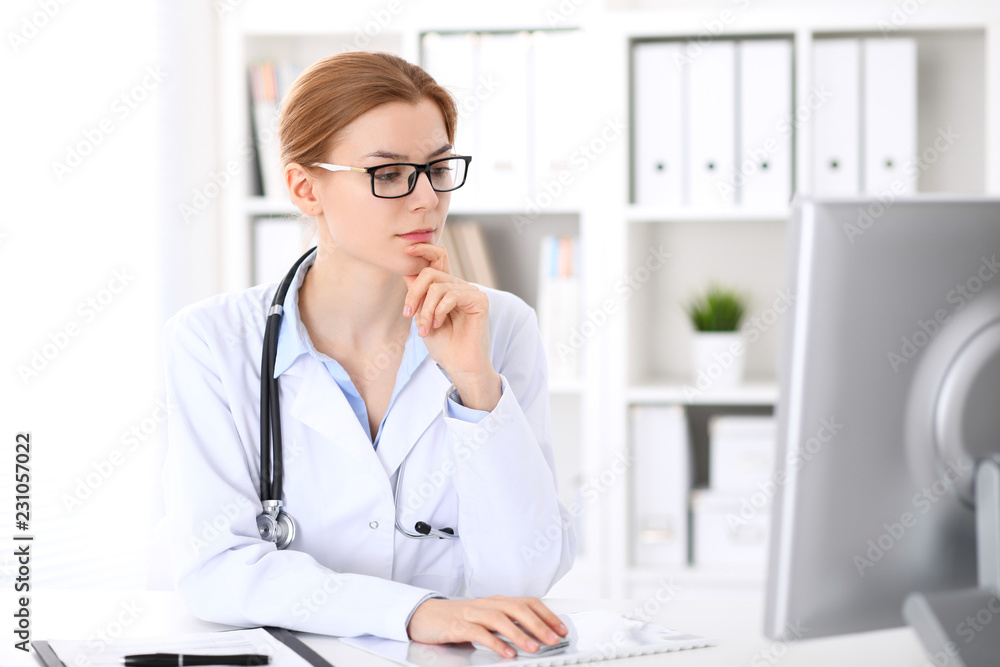 Young brunette female doctor at work in hospital.  Physician ready to help. Medicine and healthcare concept