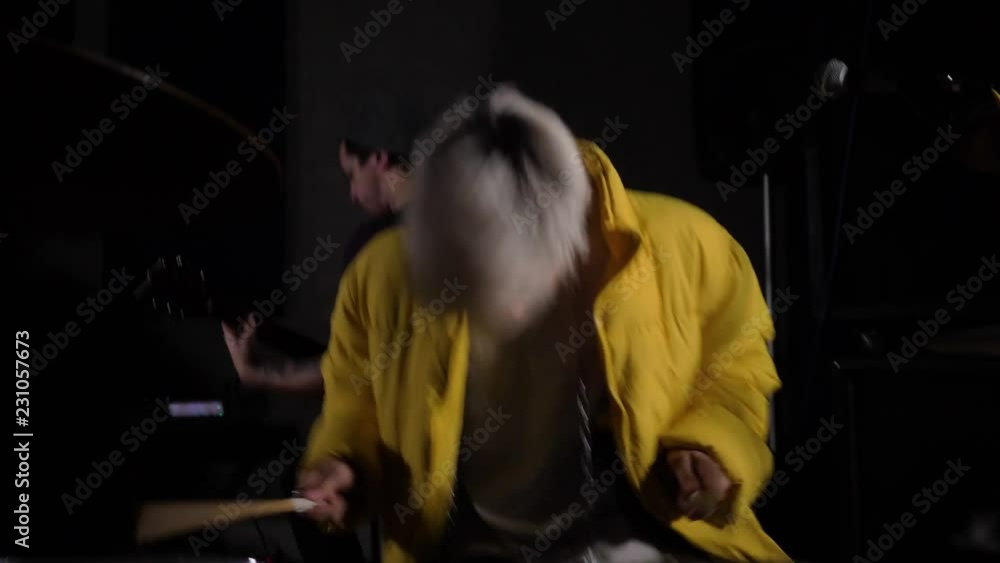 The drummer and guitarist perform in a dark studio. 4K. Shot in the style of a shaking camera. Drummer sings. The drummer and guitarist perform in a dark studio. 4K. Shot in the style of a shaking camera. Drummer sings.