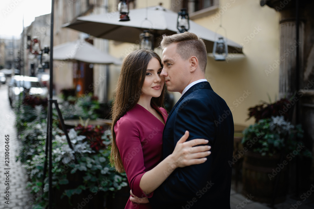 Young couple in a candid shot. They are walking in the street. Young couple in a candid shot. They are walking in the street.