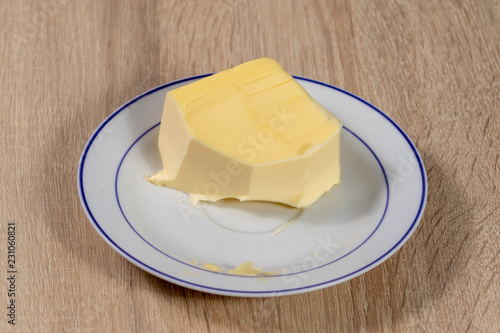 Top view on a piece of butter on a plate