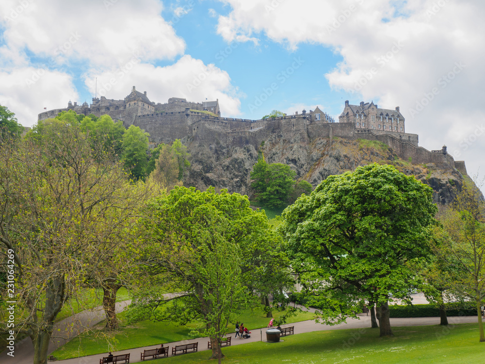 Edinburgh Castle seen from the Princes Street Gardens on a bright sunny day.
