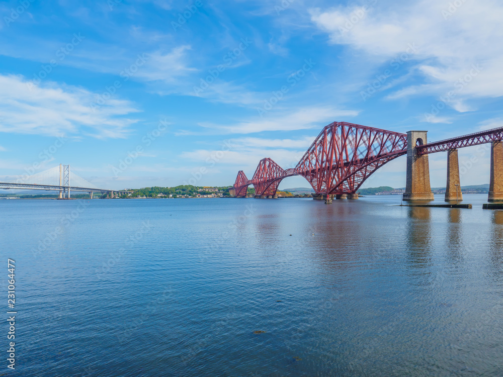 The iconic Forth Rail Bridge over the Firth of Forth (on the right) with the older Forth Road bridge (on the left) and new Queensferry Crossing bridge in the far left.