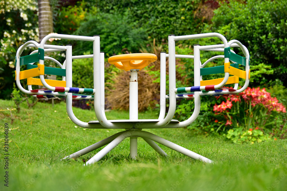 Merry-go-round in the garden in a beautiful spring afternoon outdoors Merry-go-round in the garden in a beautiful spring afternoon outdoors