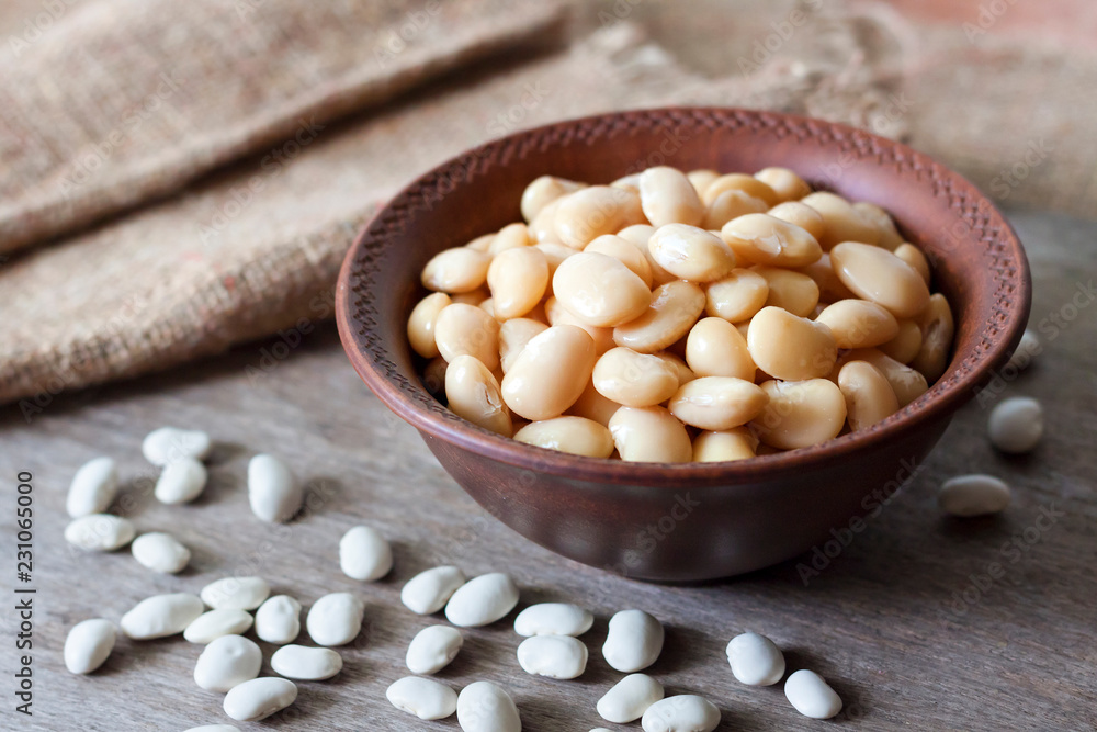 Boiled white kidney beans in a rustic bowl Boiled white kidney beans in a rustic bowl
