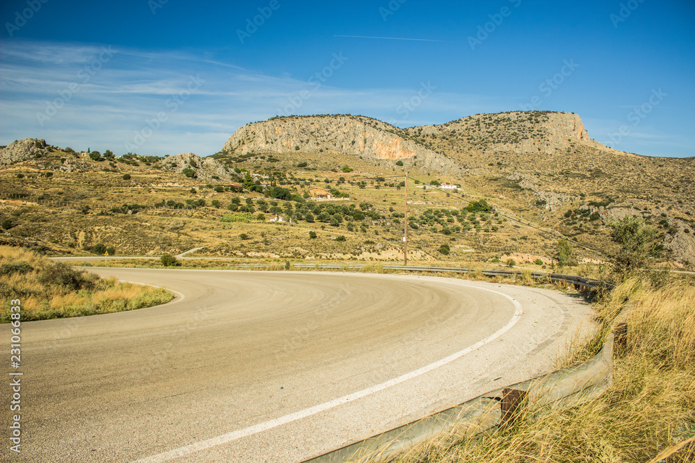 empty asphalt car road in dry summer warm place landscape with mountain rock on horizon background 