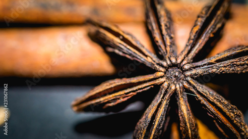various aromatic spices and herbs on black background. star anise, cloves, cardamom, cinnamon stick
