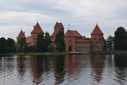 Trakai island castle at the lake. Reflection in water.