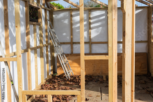 Building summer house or shed in the garden, wooden structure, waterproofed, on a stone base, selective focus