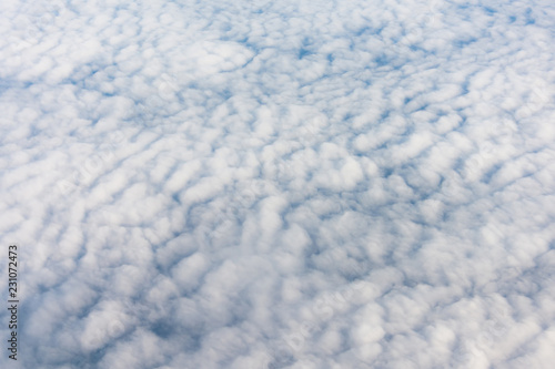 Flying in sky on altocumulus clouds, top view.