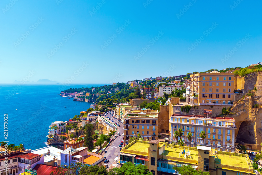 View of the coast of Naples with clear blue sky. Houses on the shore of the Gulf of Naples. Italy, Europe.