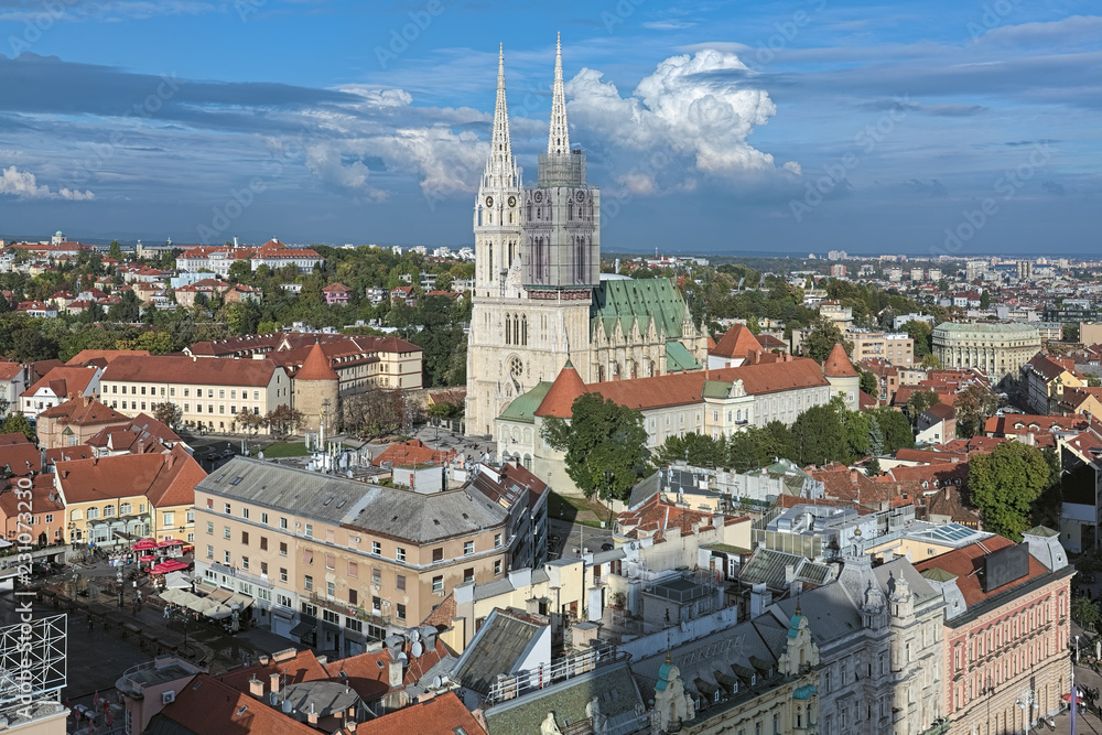 Zagreb Cathedral on the background of beautiful cumulus clouds, Croatia. View from the observation desk at Zagreb Neboder (Skyscraper).