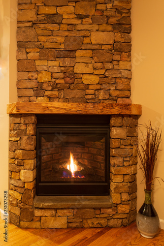 Stone fireplace with gas logs on a cold, winter night.