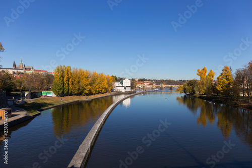 Colorful autumn Prague gothic Castle with the Lesser Town above River Vltava in the sunny Day, Czech Republic © Kajano