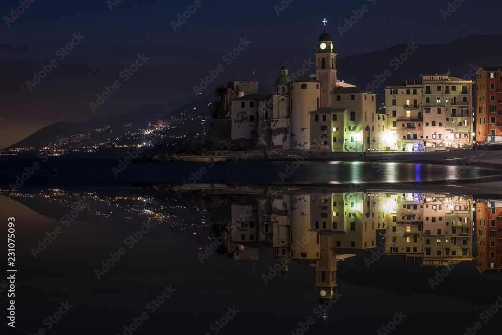 Nightly reflections of the town of Camogli. Image made with two overlaid photographs.