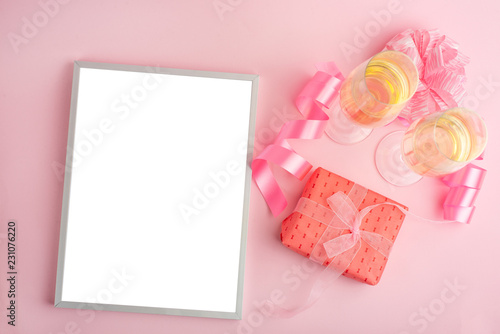 Champagne, gift, bow. Invitation, birthday, party on the occasion of girlhood, the concept of a baby shower, a holiday on a pink background. Banner for inscriptions, announcements for birthday