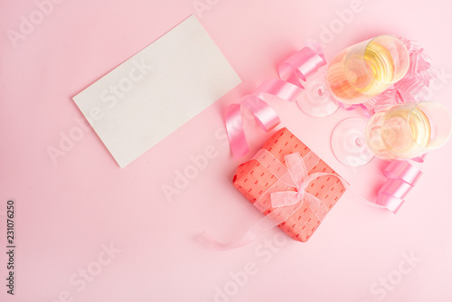 Champagne, gift, bow. Invitation, birthday, party on the occasion of girlhood, the concept of a baby shower, a holiday on a pink background. Banner for inscriptions, announcements for birthday © Anton