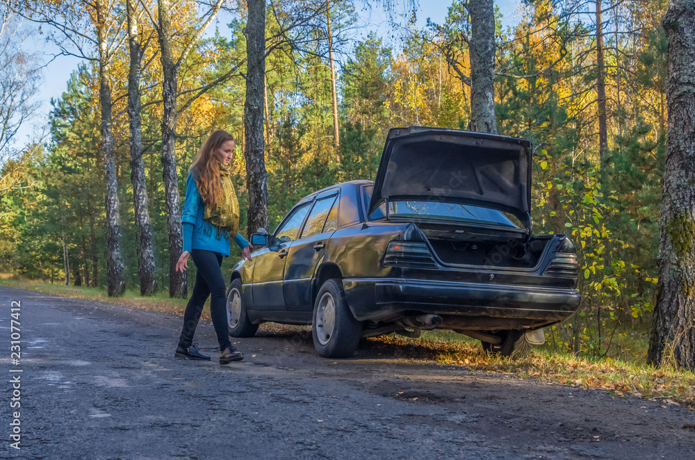 Portrait of beautiful young woman using her mobile phone calls for assistance for car. Portrait of beautiful young woman using her mobile phone calls for assistance for car.