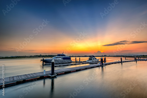 A Long Exposure picture of row of luxury sailboats reflected in water, yacht port on the bay, water transport, ocean transportation, beautiful vessel in the harbor,