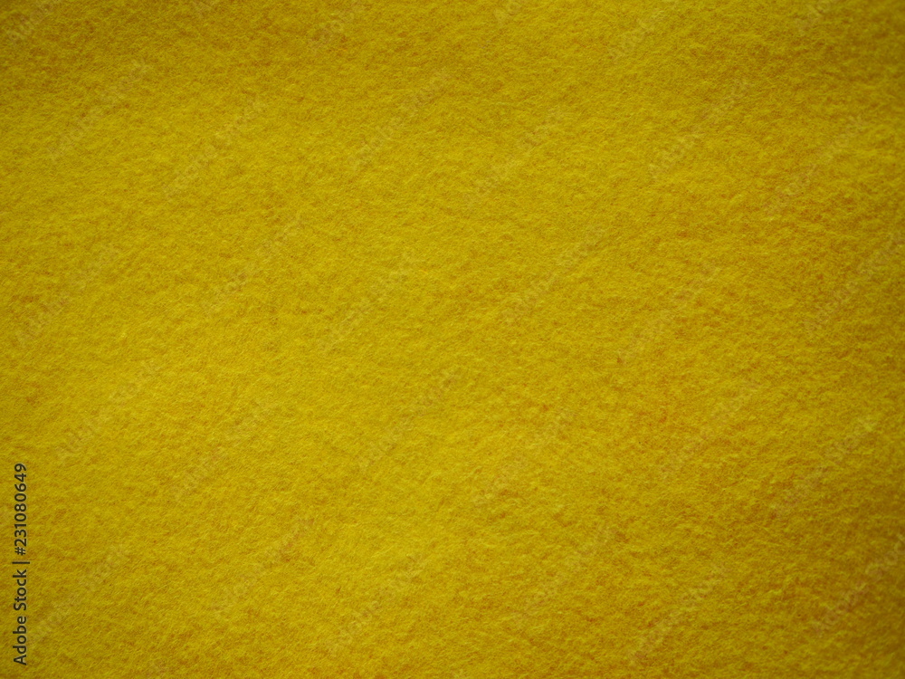 Fototapeta premium Yellow felt background, yellow texture