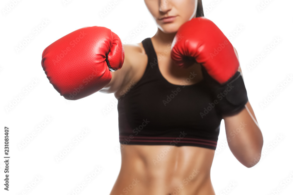 A beautiful sportswoman is boxing in the gym. Doing sports and sports life. A beautiful sportswoman is boxing in the gym. Doing sports and sports life.