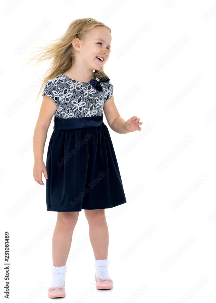 Little girl in a dress developing in the wind. Little girl in a dress developing in the wind.
