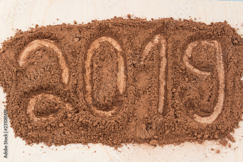 Figures 2019-the number of the new year, painted in scattered cocoa powder.