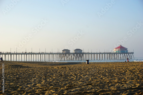 Beach with pier and people in morning