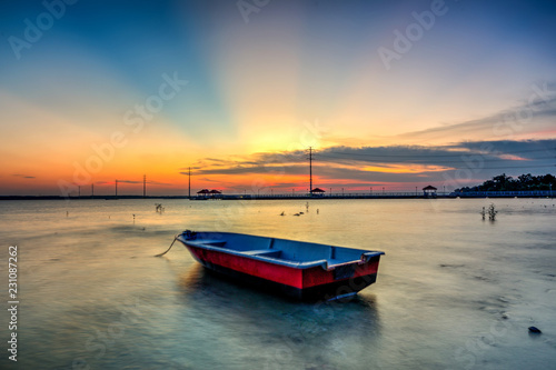 Beautiful A long exposure picture of sunset over a fishing boat