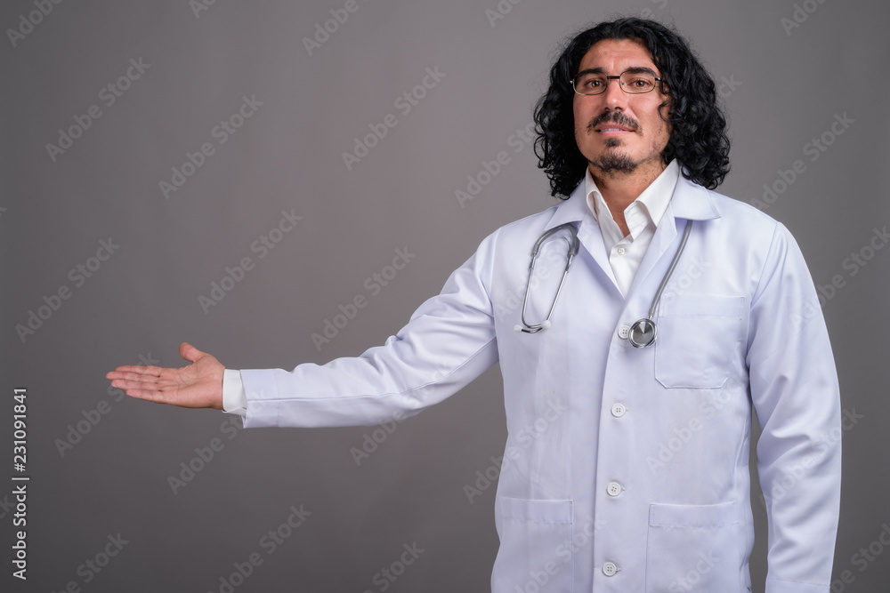 Handsome man doctor with mustache against gray background Handsome man doctor with mustache against gray background