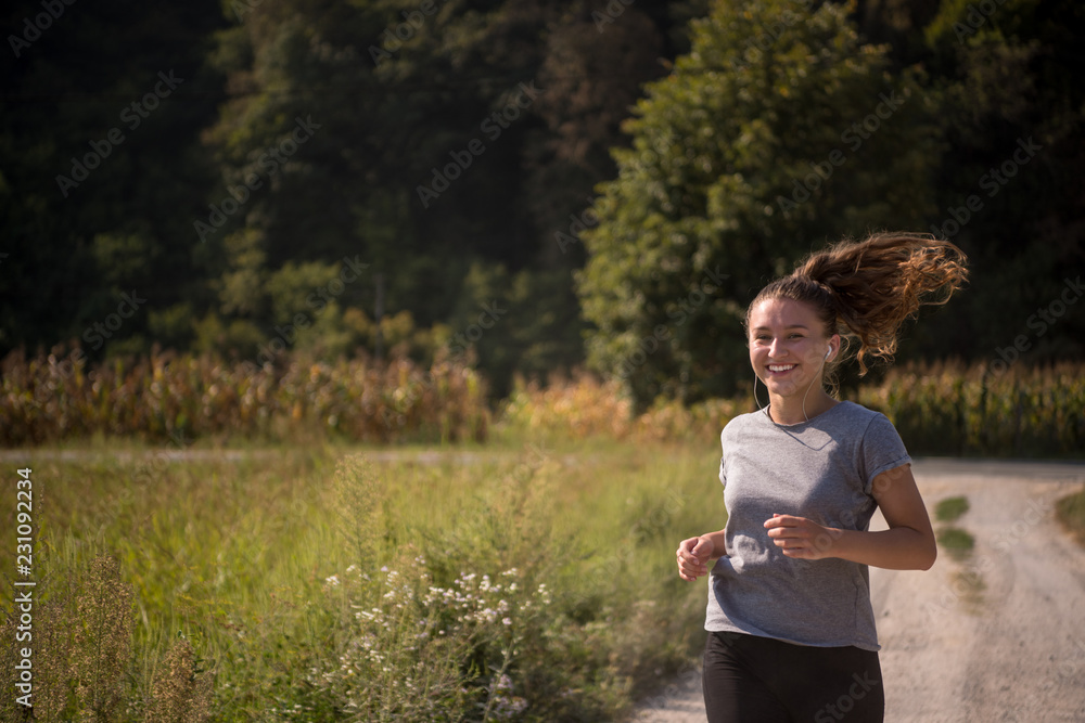 woman jogging along a country road woman jogging along a country road