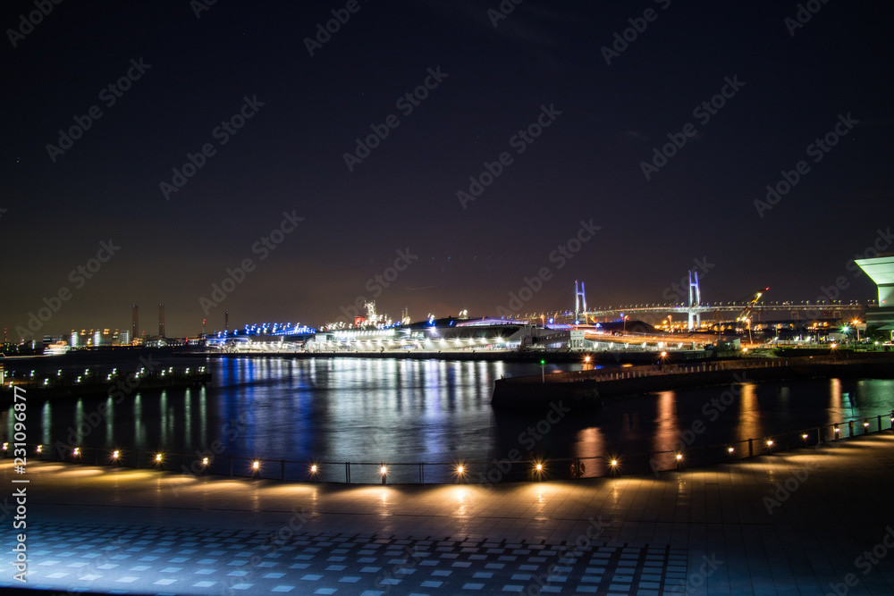 A nightscape of Yokoham bay with the Yokohama Bay Bridge in the distance