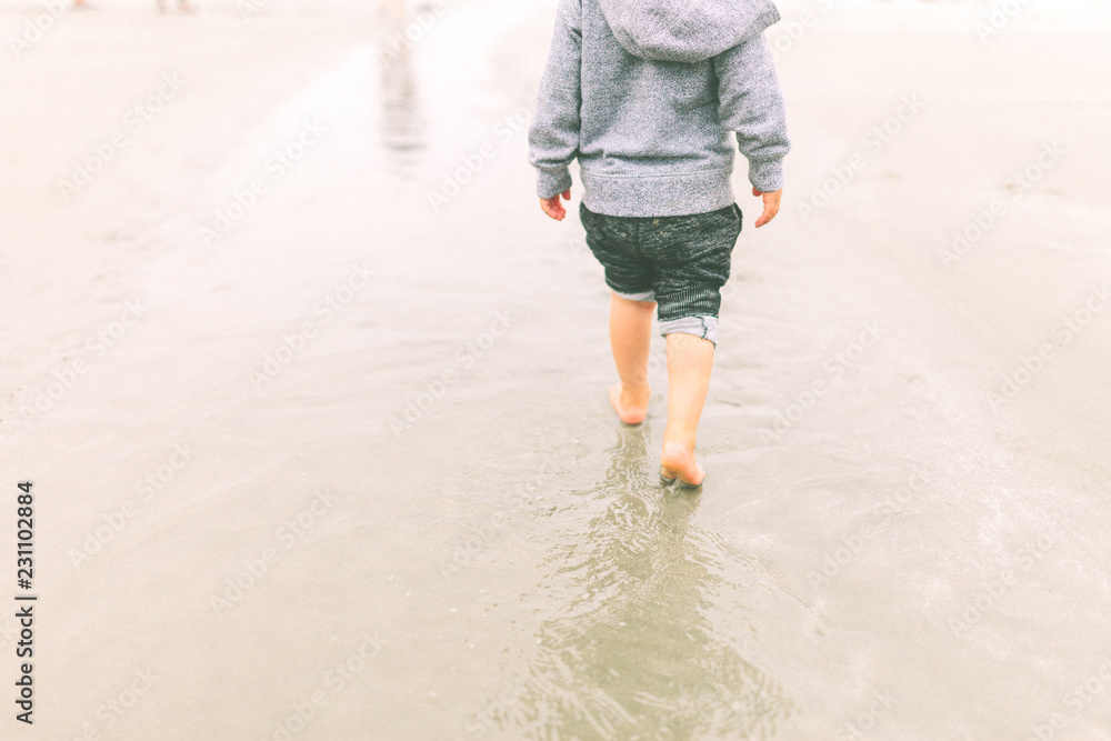 boy walking on the beach