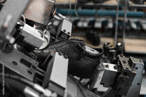 Bild auf Leinwand Man use special machine tool for making a shoes