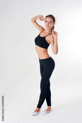 Young beautiful fitness woman doing exercise over white background