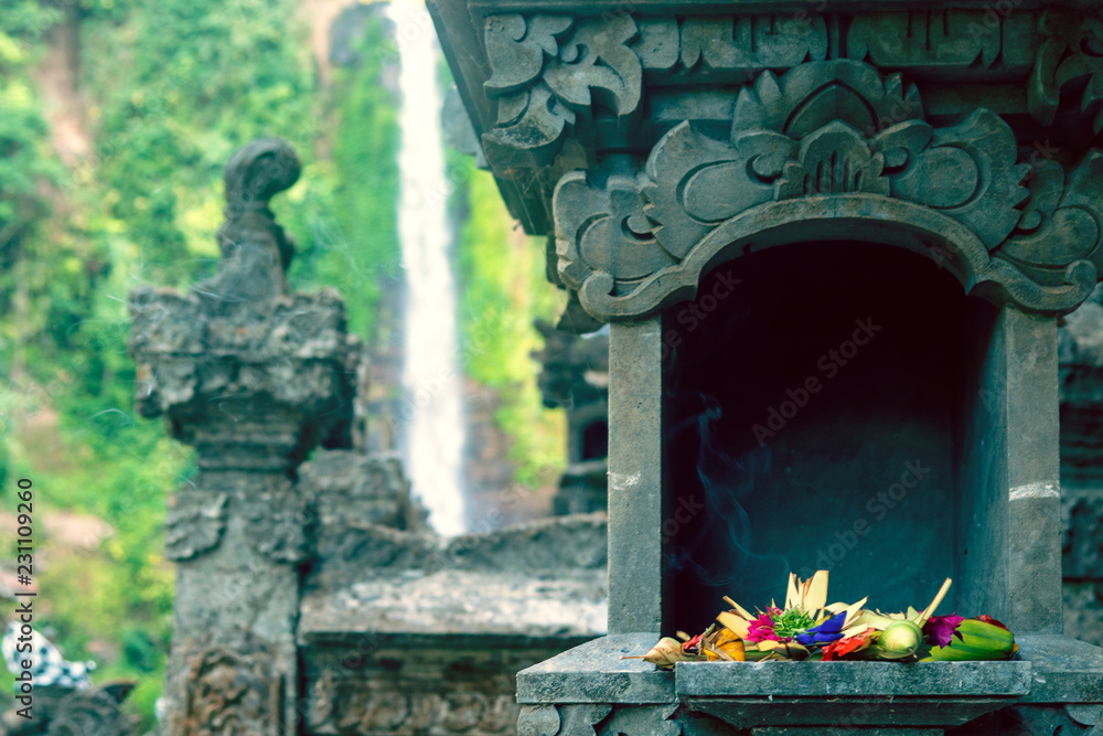 Fresh flowers and incense stick in weaved baskets for daily offerings and devotion to Hindu god for blessing and protecting people in Bali, Indonesia.