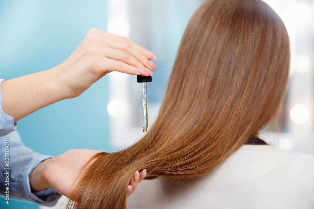 Close-up drop of oil restore and recovery hair is applied to head bulbs. hairdresser spa salon. Close-up drop of oil restore and recovery hair is applied to head bulbs. hairdresser spa salon.