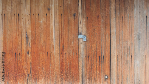 Wooden retro, vintage folding door orange color tone background has key lock in Thailand country © silamime