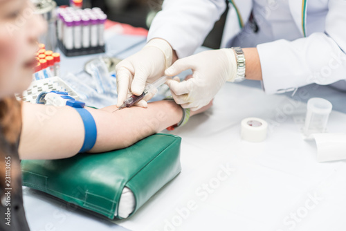 Blood sample from a vein  Nurse taking Real Blood samples analysis from a vein of the patient  laboratory on research of blood tests  to diagnose illness by means of a blood test 