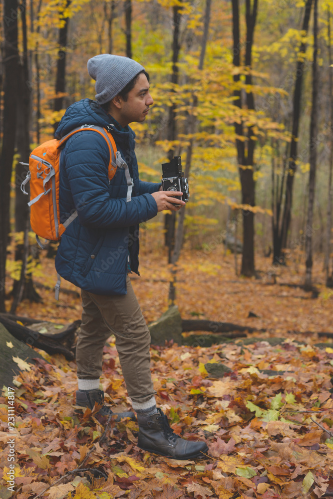 Photographer with old camera in a forest