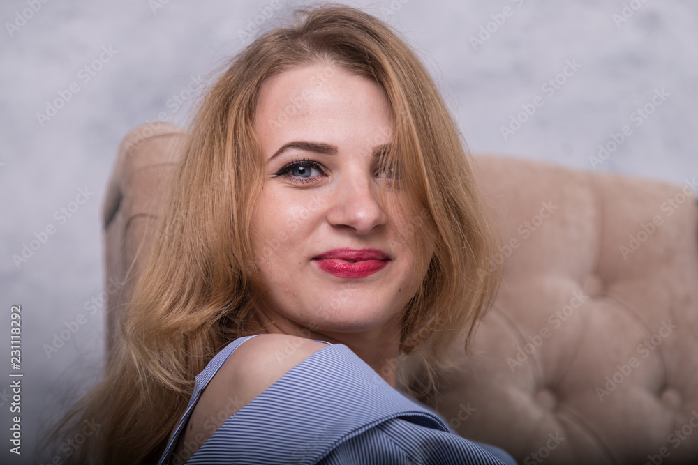 Portrait of a nice blonde girl in blue dress in the room Portrait of a nice blonde girl in blue dress in the room