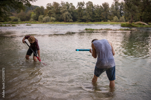 Fototapeta Naklejka Na Ścianę i Meble -  young men having fun with water guns