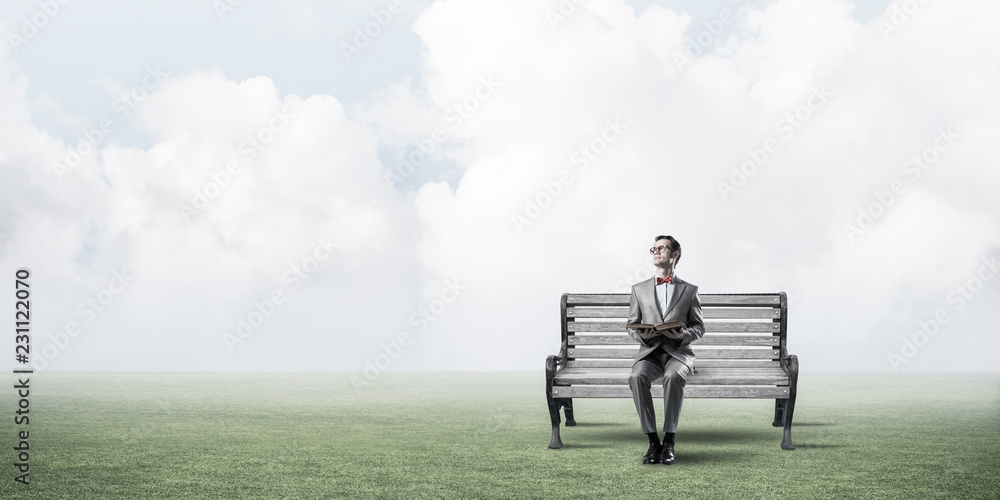 Young businessman or student studying the science in summer park