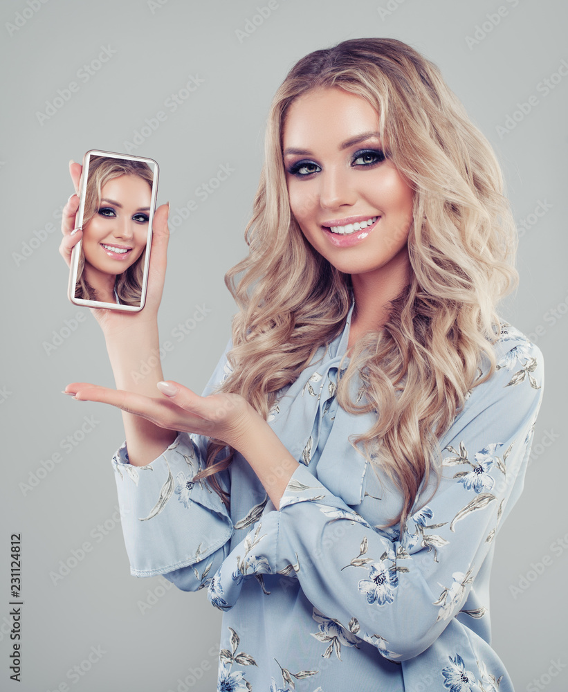 Woman with smartphone. Happy girl showing selfie photo on cell phone Woman with smartphone. Happy girl showing selfie photo on cell phone