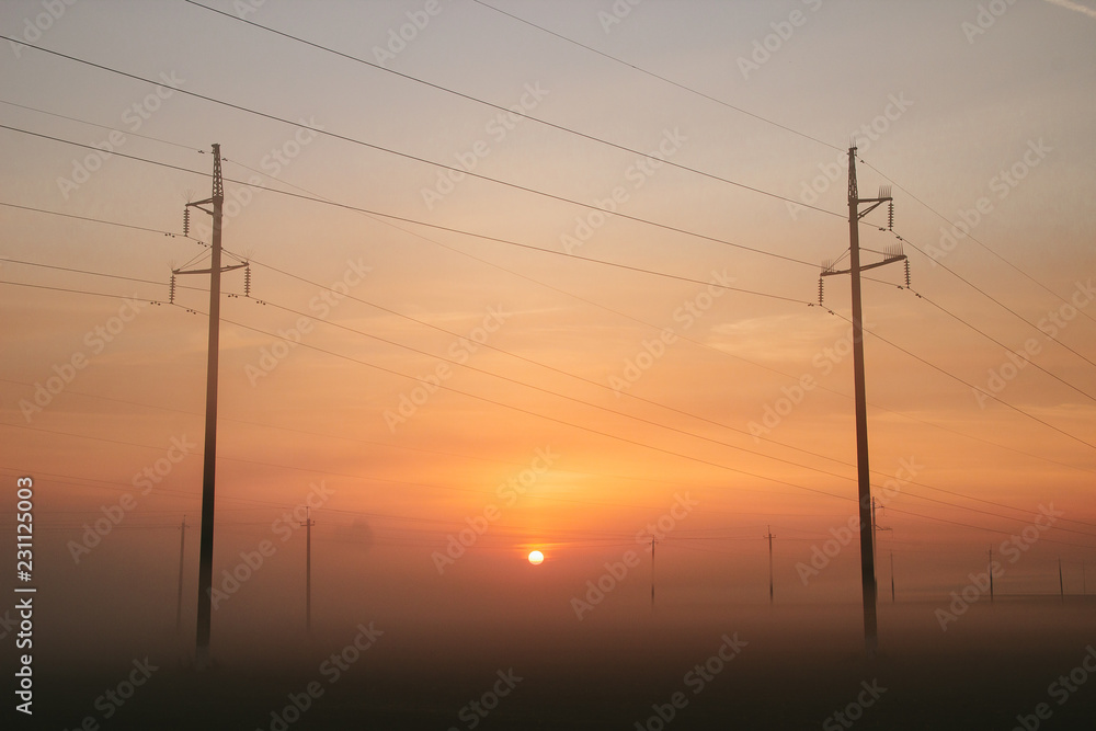 Power line in fog in the early morning