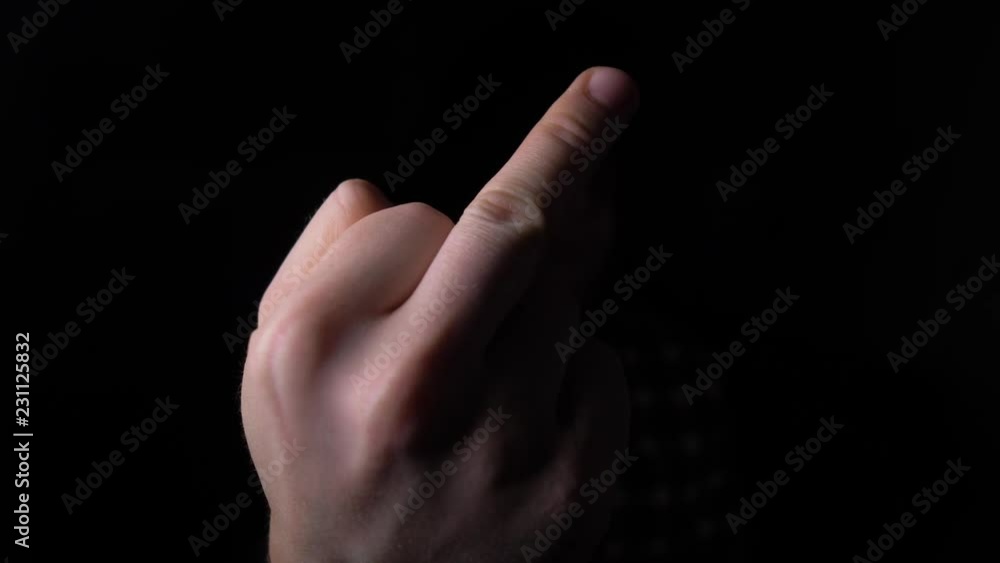 male Hand Showing Middle Finger out of the Darkness. 4K slow motion male Hand Showing Middle Finger out of the Darkness. 4K slow motion