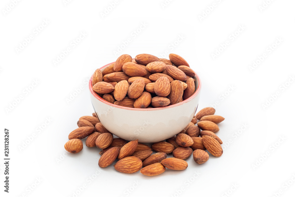Heap almonds in cup on background Heap almonds in cup on background