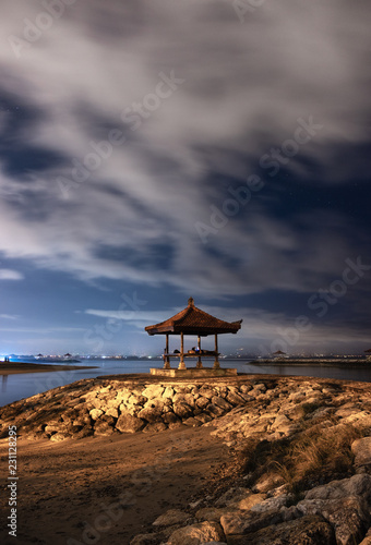 Pavilion on rock jetty with cloudy in sanur beach