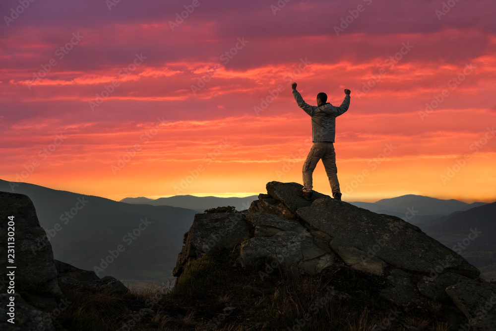 Happy male hiker on mountain top