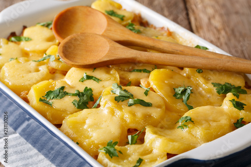 German main course casserole of sauerkraut with potatoes, bacon and cheese closeup. horizontal photo